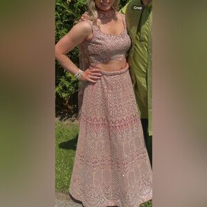 Lehenga set , peachy pink colour with reflective details.